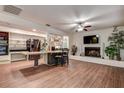 Spacious living room with hardwood floors, white brick fireplace, and built-in shelving at 2343 Wilshire Dr, Dunedin, FL 34698