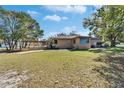 View of a one-story home with large backyard and covered patio area at 2606 N Boulevard, Tampa, FL 33602