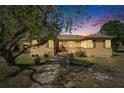 Charming one story home with a welcoming front porch at dusk at 2606 N Boulevard, Tampa, FL 33602
