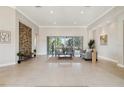 Spacious living room with a decorative stone wall and large sliding glass doors at 2769 Harvest Drive, Sarasota, FL 34240