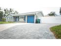 Wide driveway leading to the house, offering ample parking space and featuring a stone walkway at 302 N Lauber Way, Tampa, FL 33609