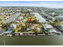 Aerial view of a beautiful waterfront home with a private dock and access to the open water at 3447 Flamingo Blvd, Hernando Beach, FL 34607