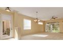 Bright living room with natural light, neutral color palette, tile floors and a ceiling fan at 4216 Preserve Pl, Palm Harbor, FL 34685