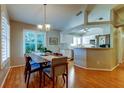 Bright dining area featuring hardwood floors, shutters, and open access to the modern kitchen at 510 Pine S Ave, Oldsmar, FL 34677