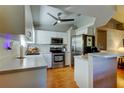 Modern kitchen features stainless steel appliances, white cabinets, and a breakfast bar for casual dining at 510 Pine S Ave, Oldsmar, FL 34677