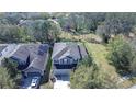 Aerial view of a home showcasing its layout, landscaping, backyard, and the surrounding neighborhood at 5411 Starling Ridge Dr, Lithia, FL 33547