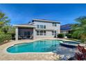 Outdoor living space featuring a pool, hot tub, screened lanai, and beautiful views of backyard at 5411 Starling Ridge Dr, Lithia, FL 33547