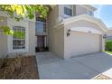 Close up of the home's front door and an attached two-car garage at 9224 Lost Mill Dr, Land O Lakes, FL 34638