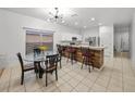 Open-concept kitchen features a breakfast bar with stylish seating and modern lighting at 9417 Cypress Harbor Dr, Gibsonton, FL 33534