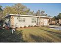 Single-story home with fresh exterior paint, stone accents, and manicured front yard at 1012 Cronley Pl, Sarasota, FL 34237
