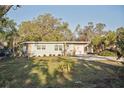 Single-story home with stone accents, fresh exterior paint, and well-maintained lawn at 1012 Cronley Pl, Sarasota, FL 34237