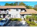 Inviting two-story home boasts a well-kept lawn, ample parking, and cozy front porch at 10131 Lake Oak Cir, Tampa, FL 33624