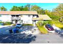 Two-story townhome with well-manicured lawn, ample parking, and convenient trash receptacles at 10131 Lake Oak Cir, Tampa, FL 33624