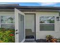 Open front door welcomes you to the home's bright interior with hardwood floors at 1054 W Baffin Dr, Venice, FL 34293