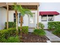 Charming front entrance with lush landscaping, creating a welcoming and inviting atmosphere for visitors at 1400 Water View W Dr # 102, Largo, FL 33771