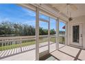 Relaxing screened porch offers panoramic views of the lake and trees, perfect for enjoying the outdoors at 1400 Water View W Dr # 102, Largo, FL 33771