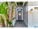 Inviting front entryway with a decorative door, stone flooring and lovely landscaping at 1453 Appleton Pl, Wesley Chapel, FL 33543