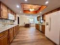 Well-appointed kitchen boasts ample counter space, wood cabinets, and modern appliances with an open concept at 1811 Tawnee Pl, Brandon, FL 33510