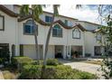 This townhouse exterior has garages, arched windows, and lush landscaping for added curb appeal at 325 Madeira Cir, Tierra Verde, FL 33715
