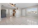 Inviting living area with tile flooring, ceiling fan, and views into the adjacent kitchen at 350 51St N Ave, St Petersburg, FL 33703