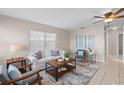 Inviting living room features neutral walls, ceiling fan, comfortable seating, and tile flooring at 350 51St N Ave, St Petersburg, FL 33703