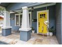 Close up of front door with two stately columns and tiled porch at 5915 N Otis Ave, Tampa, FL 33604