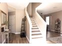 Inviting entryway with wood floors, a staircase, and neutral decor creating a warm welcome at 8556 Tidal Bay Ln, Tampa, FL 33635