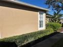 The exterior boasts a painted facade and neatly trimmed shrubs along the walkway at 8603 Egret Point Ct, Tampa, FL 33647
