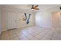 Inviting living room with neutral tile flooring, ample natural light, and a ceiling fan at 8792 93Rd St, Seminole, FL 33777