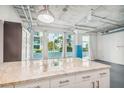 Modern kitchen with an island and large windows allowing for lots of natural light at 101 N 12Th St # 306, Tampa, FL 33602