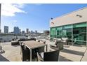 A rooftop deck with outdoor furniture and stunning views of the city skyline at 101 N 12Th St # 306, Tampa, FL 33602