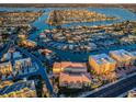 Expansive aerial view of a waterfront condominium community with a pool and waterway access at 11595 Gulf Blvd # 6, Treasure Island, FL 33706