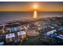 Sunset aerial view of a beachfront condominium community, featuring a stunning ocean view at 11595 Gulf Blvd # 6, Treasure Island, FL 33706