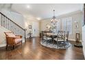 Elegant dining room with a decorative chandelier, staircase, and light-filled windows at 11639 Sweet Tangerine Ln, Tampa, FL 33626