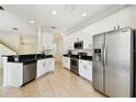Bright kitchen featuring stainless steel appliances, white cabinetry, and granite countertops at 14542 Mirabelle Vista Cir, Tampa, FL 33626