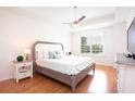 Inviting main bedroom with a ceiling fan, wood floors, and plenty of natural light at 14542 Mirabelle Vista Cir, Tampa, FL 33626