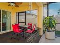 A cozy screened porch with a dining set, potted plant, and sunlit views, perfect for outdoor relaxation at 15425 Long Cypress Dr, Ruskin, FL 33573