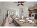 Elegant dining area featuring a beautifully set table and access to the outdoor patio at 1549 San Christopher Dr, Dunedin, FL 34698