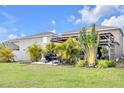 Lush backyard features a patio area, grill, pergola and ample greenery for outdoor enjoyment and relaxation at 1785 Broad Winged Hawk Dr, Ruskin, FL 33570