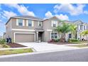 Well-maintained home offers a spacious driveway, lush front yard with vibrant landscaping and an attached two-car garage at 1785 Broad Winged Hawk Dr, Ruskin, FL 33570