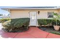 Charming condo entrance with a vibrant walkway, well-maintained bushes and a white trimmed front door at 2175 Corinne S Ct # A, St Petersburg, FL 33712