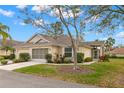 Charming home with a well-manicured lawn, beautiful landscaping, and an attached garage at 2469 Nantucket Harbor Loop # 123, Sun City Center, FL 33573