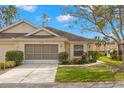 Charming home with a well-manicured lawn, beautiful landscaping, and an attached garage at 2469 Nantucket Harbor Loop # 123, Sun City Center, FL 33573