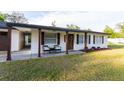 Welcoming covered front porch with seating and a wreath-adorned front door, perfect for relaxing at 38811 Inez Ave, Zephyrhills, FL 33542