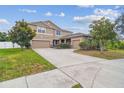 A charming two-story home with a spacious three-car garage and well-manicured landscaping at 501 Washita Stone Dr, Ruskin, FL 33570