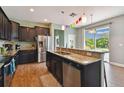 An inviting kitchen with a breakfast bar, dark wood cabinets, and stainless steel appliances at 501 Washita Stone Dr, Ruskin, FL 33570