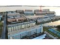 Elevated view of waterfront condos showing parking, docks, tennis courts, and water access at 6025 Shore S Blvd # 611, Gulfport, FL 33707
