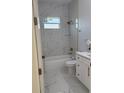 Bathroom with modern fixtures, white marble tiling in the shower, and white vanity at 6344 Skyline Ct, Spring Hill, FL 34606