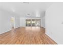 Expansive living area with wood-look floors and sliding glass doors offering views of the outdoors at 7183 Fireside St, Spring Hill, FL 34606