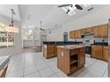 Spacious kitchen with wooden cabinets, black countertops, and stainless steel appliances at 759 House Wren Cir, Palm Harbor, FL 34683